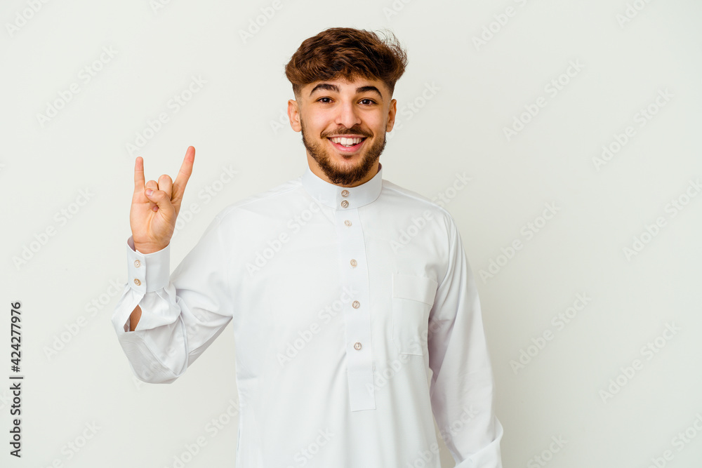 Young Moroccan man wearing a typical arab clothes isolated on white background showing a horns gesture as a revolution concept. Young Moroccan man wearing a typical arab clothes isolated on white background showing a horns gesture as a revolution concept.