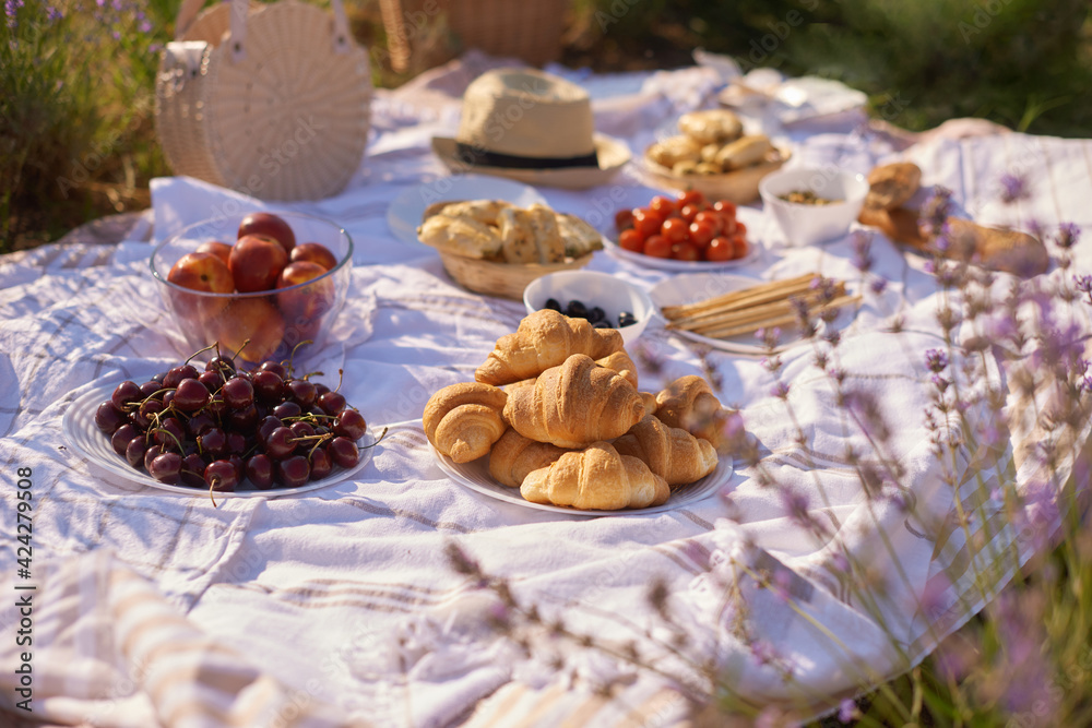 summer picnic in lavender fields. still life summer outdoor picnic with bread, berry
