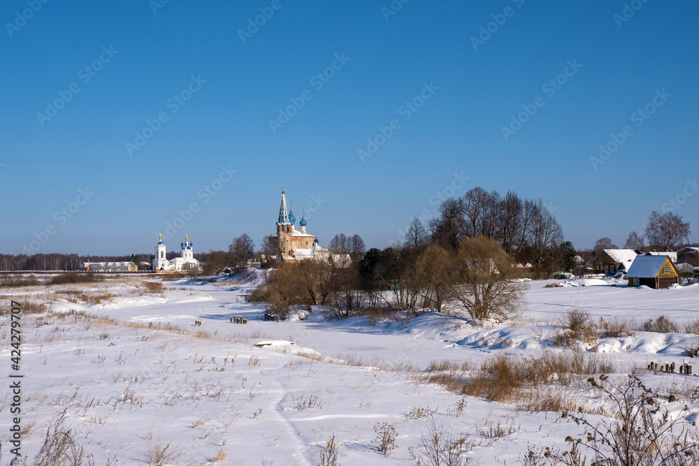 Churches in the village of Dunilovo, Ivanovo region, on a sunny winter day.
