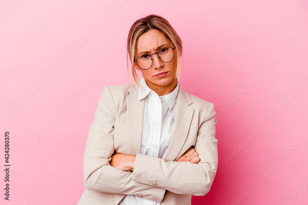 Young caucasian mixed race business woman isolated on pink background unhappy looking in camera with sarcastic expression. Young caucasian mixed race business woman isolated on pink background unhappy looking in camera with sarcastic expression.