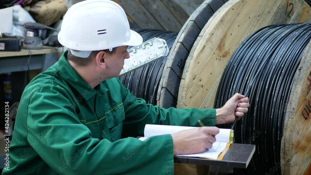 A communications engineer works with an optical fiber cable.