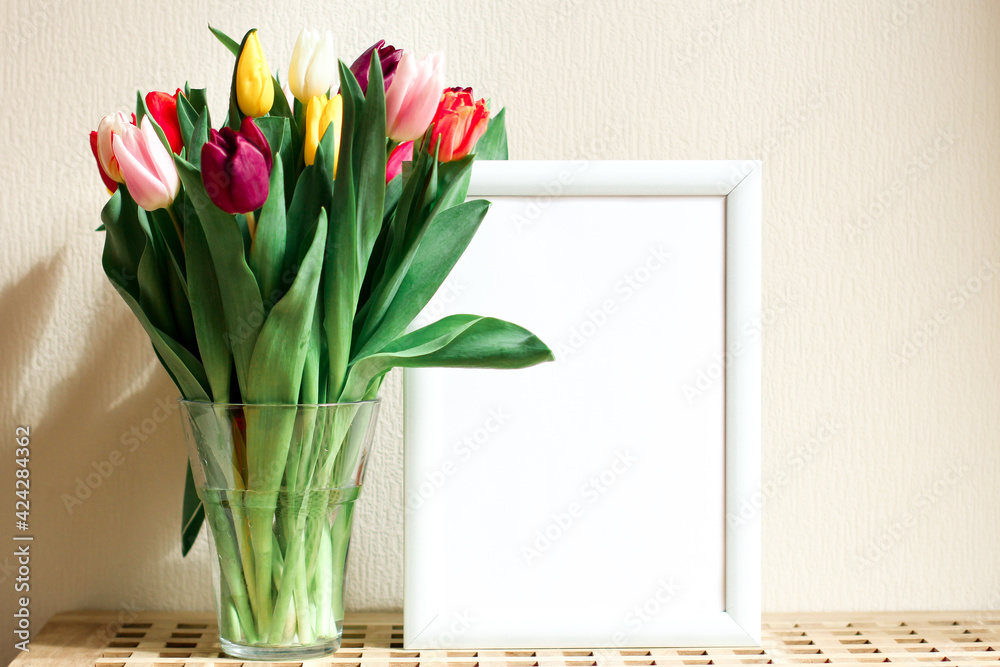 Poster with copy space in warm shades . Mockup of a wooden frame with tulips. White, minimalism. copy space. Mock up design. Poster with copy space in warm shades . Mockup of a wooden frame with tulips. White, minimalism. copy space. Mock up design.