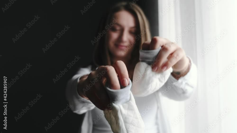 Pregnant woman standing near the window at home Pregnant woman standing near the window at home