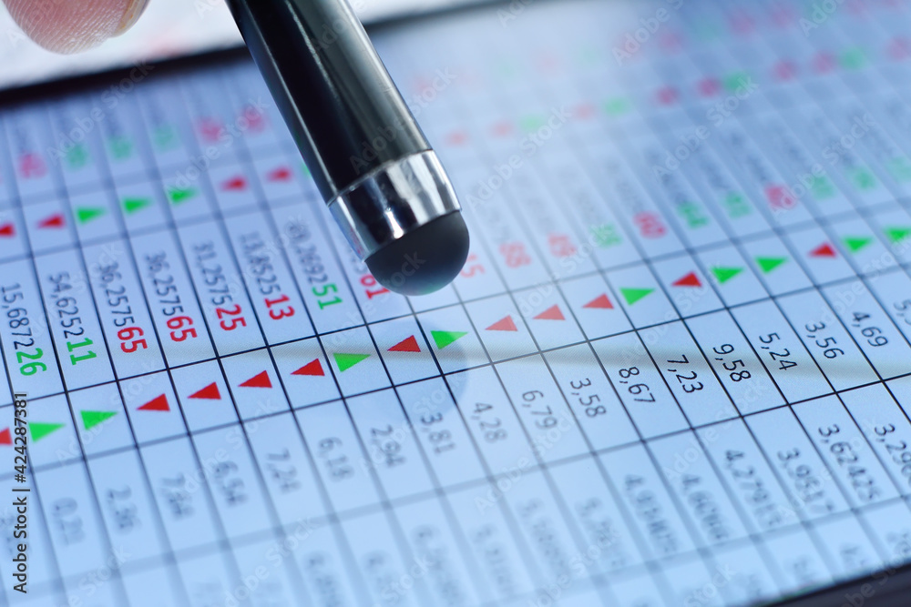 Stylus points to financial stock data on mobile phone screen. Stylus points to financial stock data on mobile phone screen.