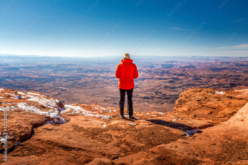 Female tourist standing at the Needles Overlook to the Canyonlands National Park, Utah