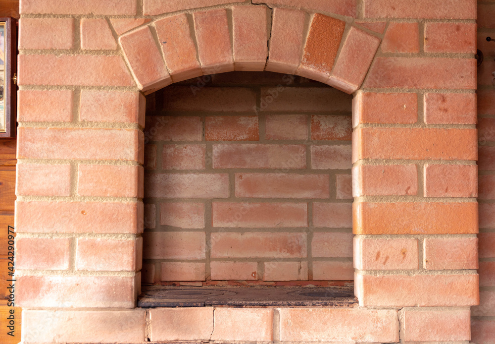 Traditional brick wood-burning stove with cooking stove, hearth