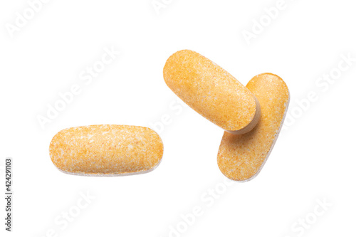Photos Orange Oval Pills On a White Background