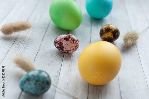 Easter eggs on a light wooden background. Easter holiday with colored eggs