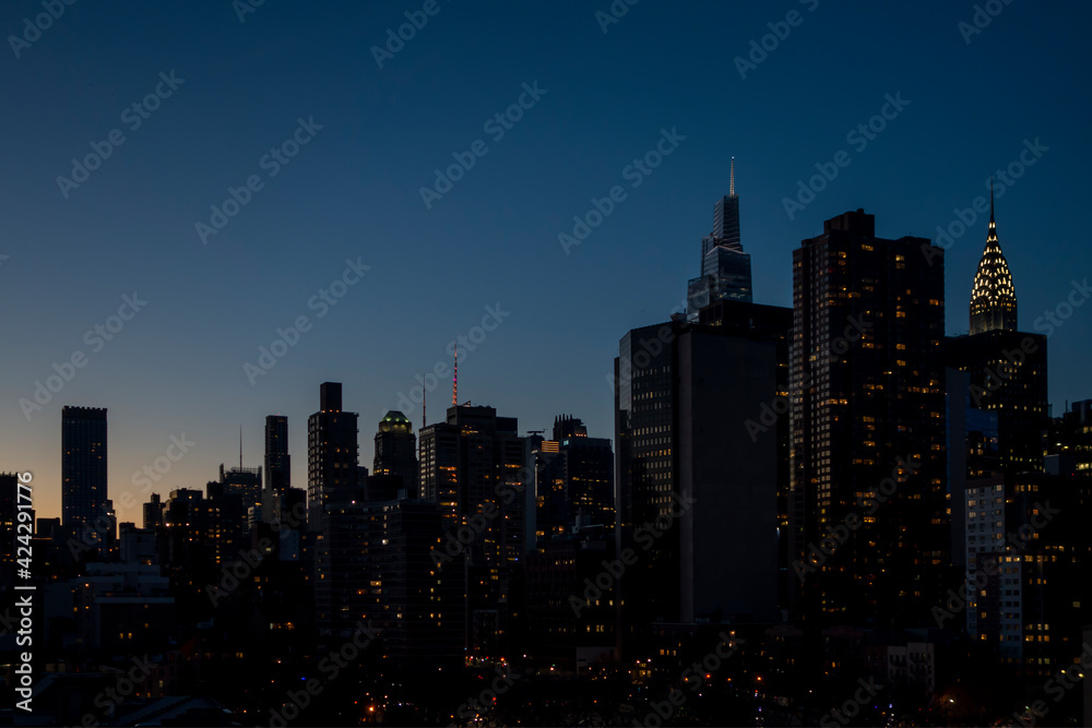 New york city building night sky with lights and setting sun