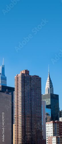 Blue sky with new york city buildings and sky skyscrapers © Mirror-images