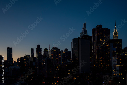 New york city building night sky with lights and setting sun