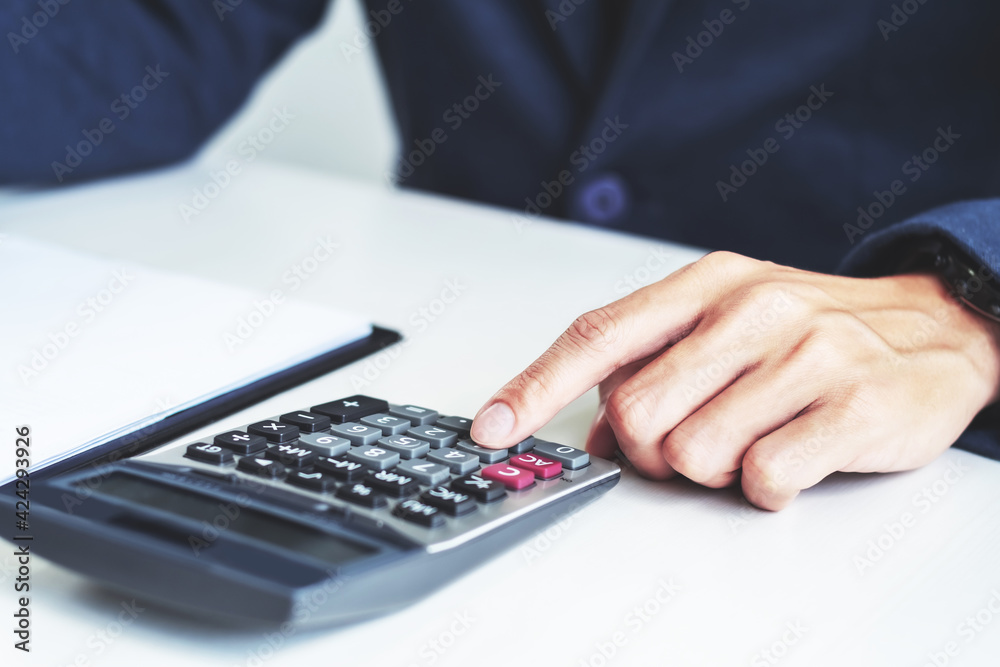 Investor calculating profits on stock market exchange.Investment planing and strategy concept Investor calculating profits on stock market exchange.Investment planing and strategy concept