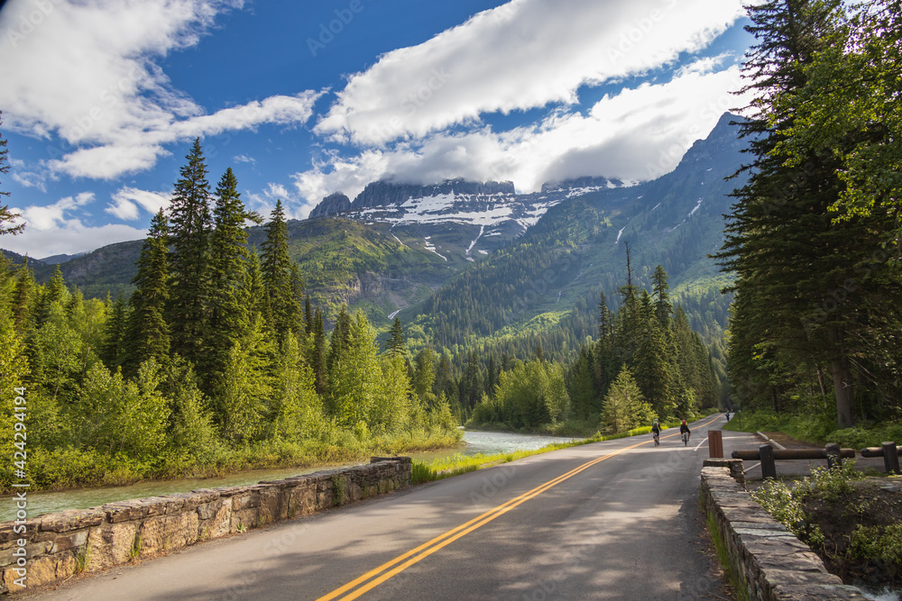 Bikers on the Going-to-the-Sun Road with mountain background, Glacier National Park, Montana