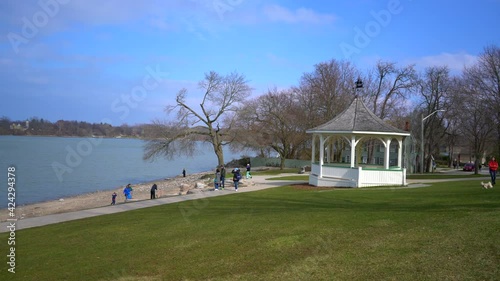 Gazebo at Niagara-On-The-Lake near beach and lake view on beautiful bright day with bright blue sky with people enjoying life and walking around with grass and sand photo