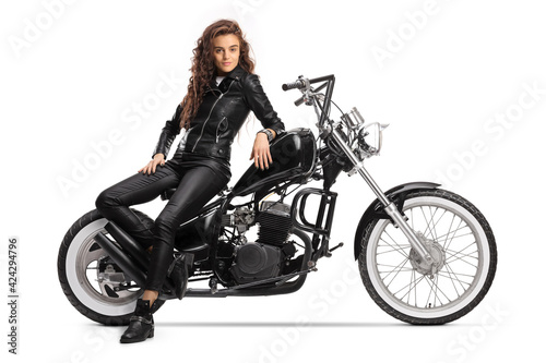 Billede på lærred Young woman sitting on a chopper motorbike