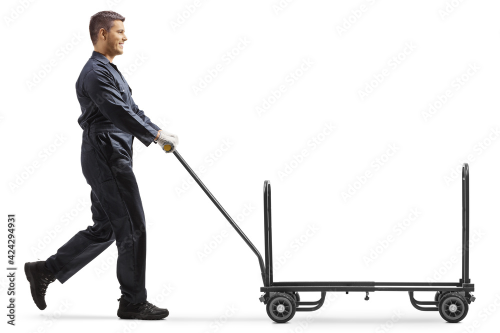 Worker in a uniform pushing an empty hand truck Worker in a uniform pushing an empty hand truck