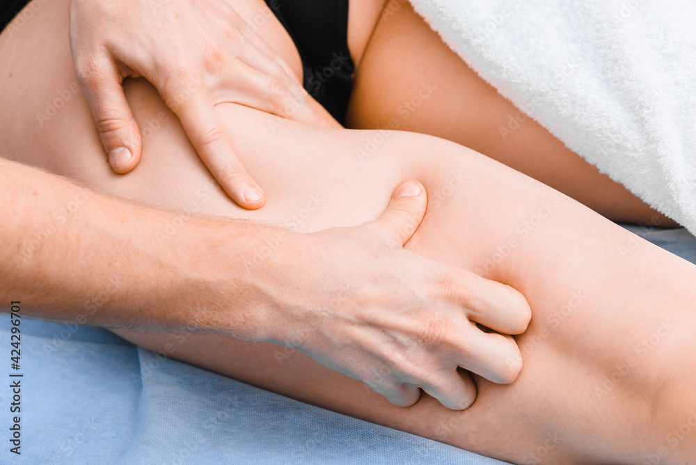 Manual anti-cellulite massage of the thighs. Hands of masseur close up. Manual anti-cellulite massage of the thighs. Hands of masseur close up.