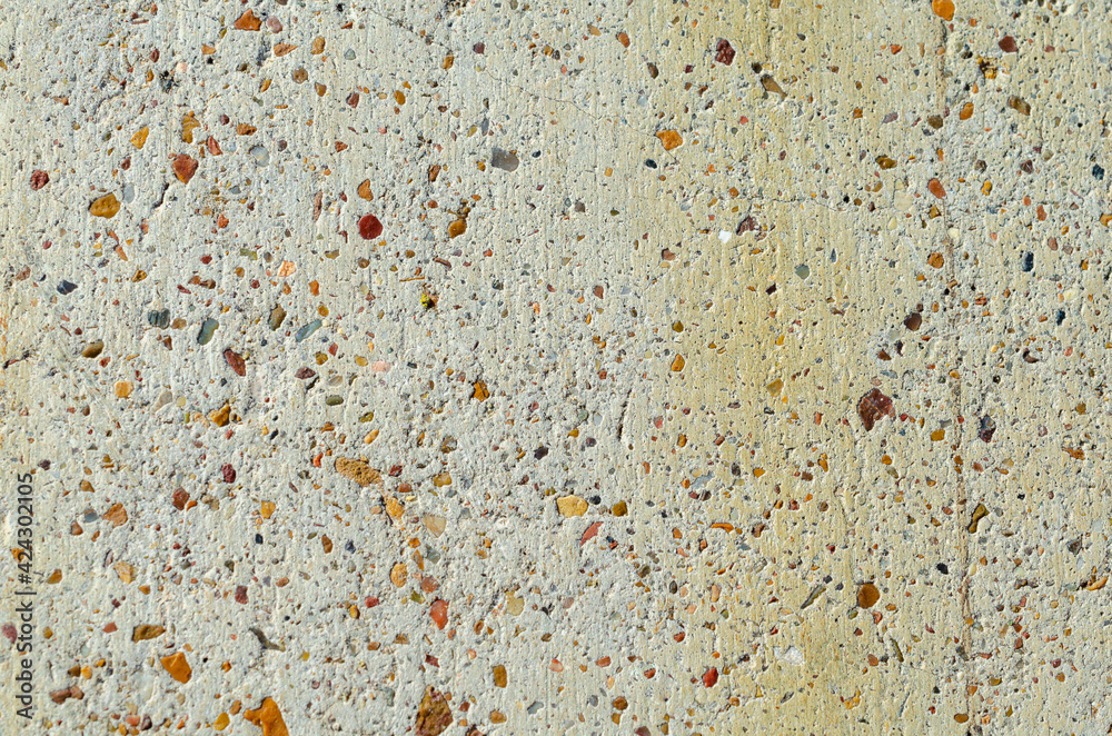 Concrete wall with small stones.