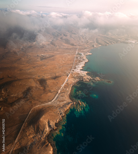 Aerial view of a road driving the coastline along the wild coastline in Cabo de Gata-Nijar facing the Mediterranean Sea, Spain. photo