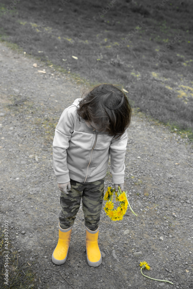 sad girl in yellow boots holds yellow flowers sad girl in yellow boots holds yellow flowers