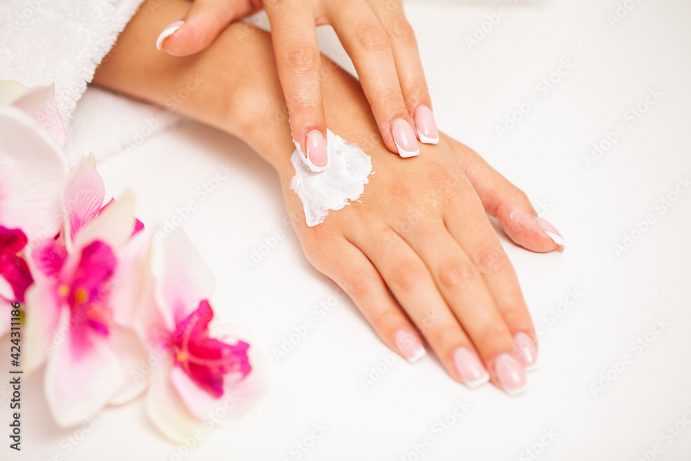 Fototapeta premium Woman use skin care products at home in light bathroom