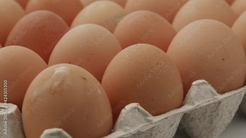 Eggs in a cardboard box, rotation shot, Chicken white fresh raw eggs in an egg container. Egg Box With Eggs On white Table Panning. Open egg box with ten brown eggs. Many fresh raw chicken eggs in car Eggs in a cardboard box, rotation shot, Chicken white fresh raw eggs in an egg container. Egg Box With Eggs On white Table Panning. Open egg box with ten brown eggs. Many fresh raw chicken eggs in car