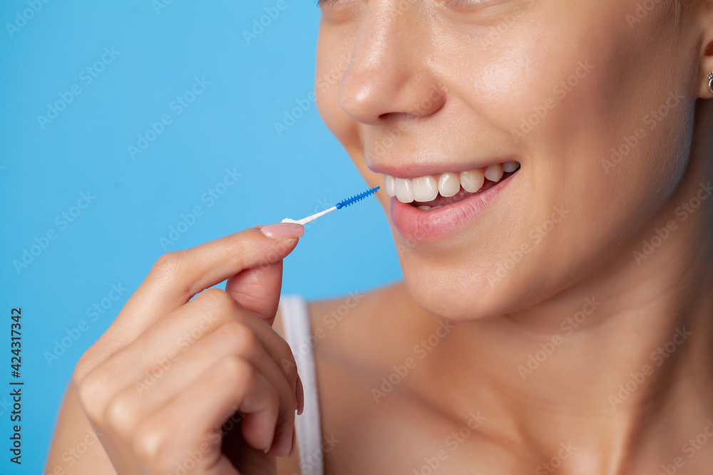 Woman uses brushes to clean the interdental spaces Woman uses brushes to clean the interdental spaces