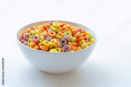 Sweetened Cereal fruit-flavored ring-shaped on a variety of bright colors and a blend of fruit flavors. Red, orange, yellow, green, blue and purple ring-shaped