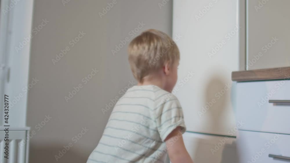 Little boy opens the refrigerator and takes yogurt at night Little boy opens the refrigerator and takes yogurt at night