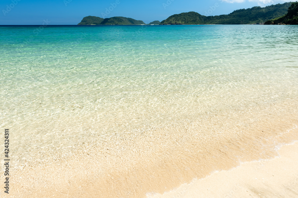 Beautiful white sand beach, crystal clear turquoise water that extends to the horizon, perfect for swimming and relaxing. Iriomote Island. Beautiful white sand beach, crystal clear turquoise water that extends to the horizon, perfect for swimming and relaxing. Iriomote Island.