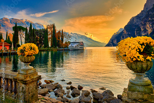 View of the beautiful Lake Garda surrounded by mountains, Scenic view of sunset at Lake Garda in the evening with the beautiful sunset colors, italy