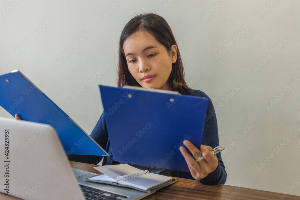 Young business supervisor reading the sales reports Young business supervisor reading the sales reports