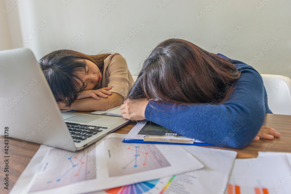 Tired Asian office woman sleeping in the office Tired Asian office woman sleeping in the office