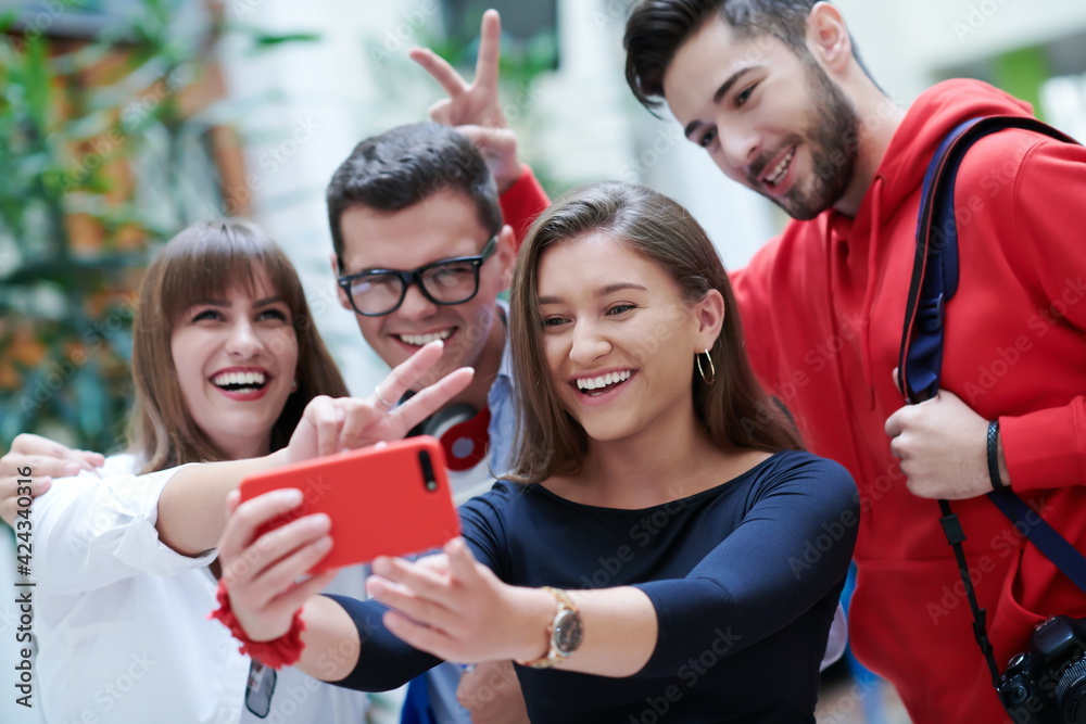 Obraz premium Group of multiethnic teenagers taking a selfie in school