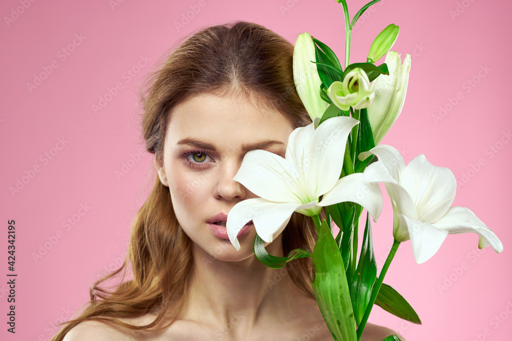 Portrait of woman with white flowers beautiful face pink background naked shoulders Portrait of woman with white flowers beautiful face pink background naked shoulders