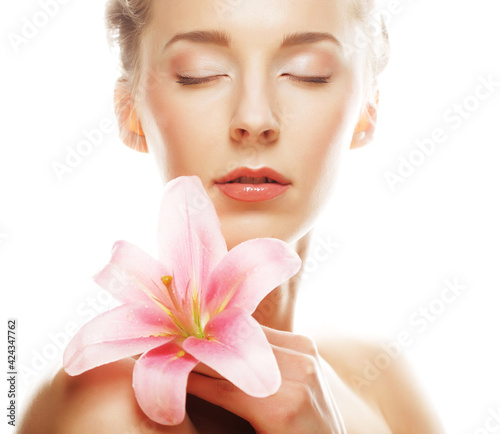 Beauty face of woman with pink lily