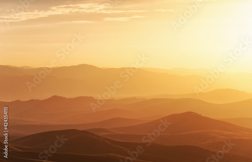 Sunset light over the mountains view from the mountain sky in golden shade mystical light, Babyrgan