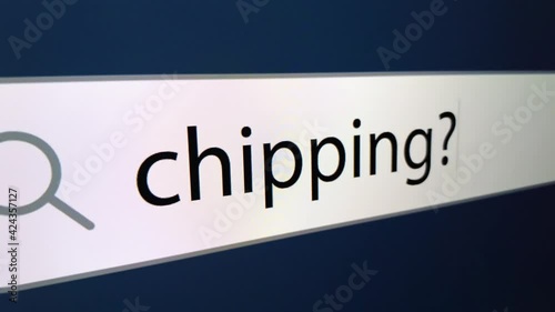 Chipping written in search bar with cursor and question mark at the end,a computer monitor, close-up with the effect of a camera zoom
