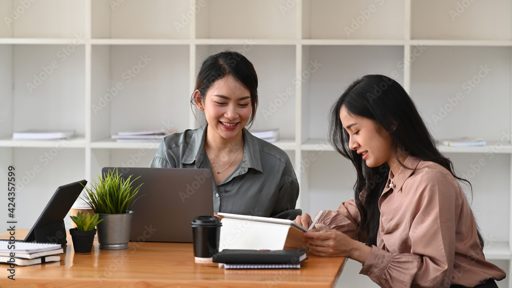 Cropped shot of two business colleagues working with digital tablet and discussing business data at office. Cropped shot of two business colleagues working with digital tablet and discussing business data at office.