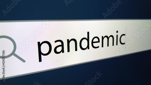 Pandemic written in search bar with cursor and question mark at the end,a computer monitor, close-up with the effect of a camera zoom