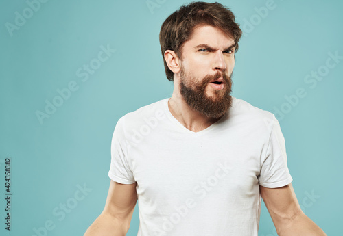 Cute man with beard on blue background emotions Copy Space cropped view