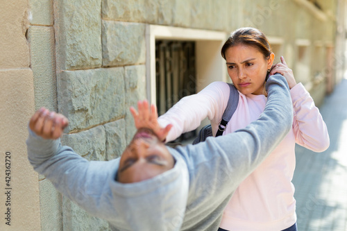 Obraz na płótnie Woman defends herself from attacker rapist on the street
