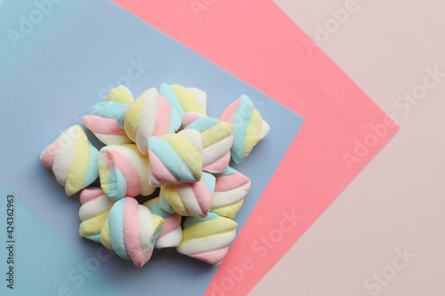 Marshmallows in pastel color on blue and pink background -Top view with copy space