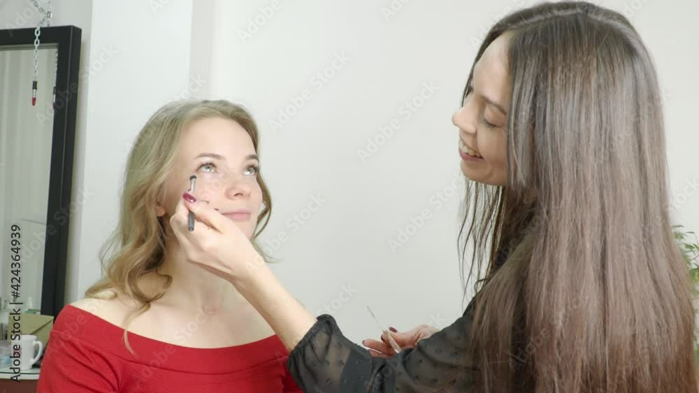 beautiful blonde in a beauty salon, does makeup beautiful blonde in a beauty salon, does makeup