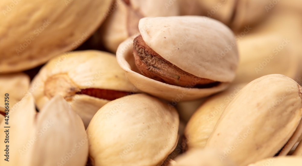 Fototapeta premium Close-up of fresh pistachio nuts as background.