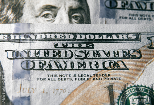 The United States of America sign on the one hundred dollar bill. Close up shot with sharp texture. Macro shot of US Dollar money. photo