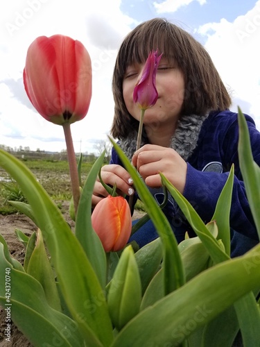 girl with tulips child in the field 