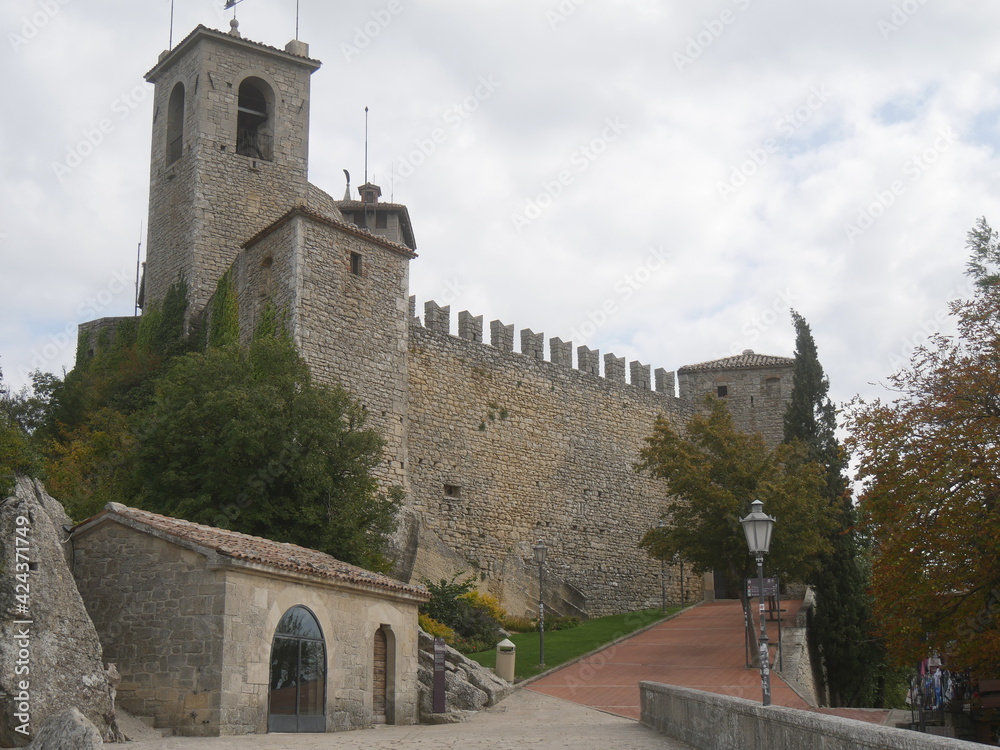 San Marino, First Tower. Front of the castle surrounded by mighty stone walls, the bell tower and the entrance door that was a drawbridge