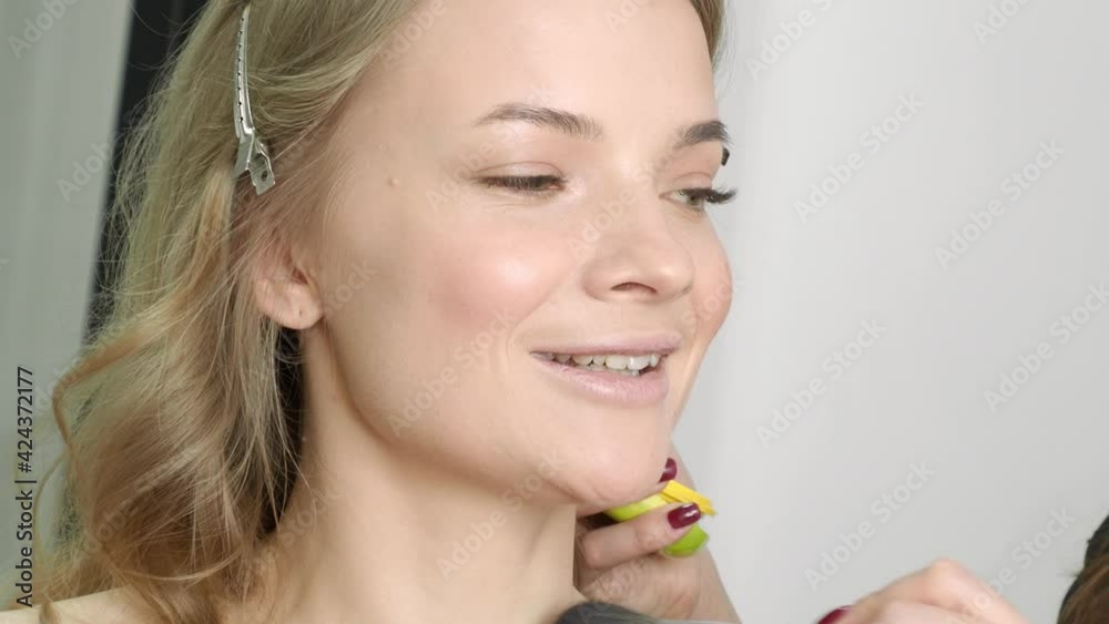 beautiful blonde in a beauty salon, does makeup beautiful blonde in a beauty salon, does makeup
