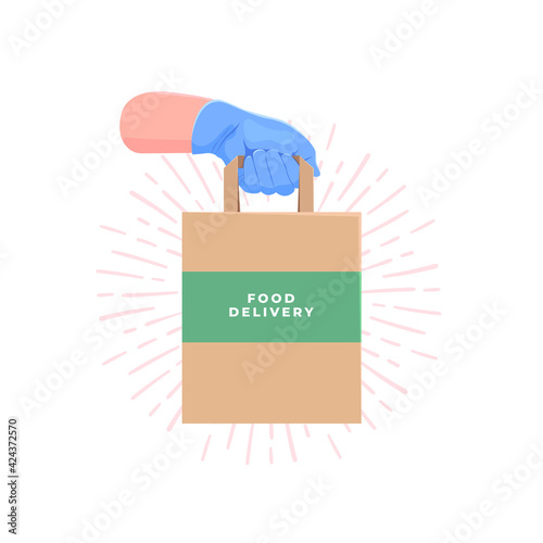 Couriers hand in blue protective rubber glove holding delivery paper bag with food. Safe food delivery.